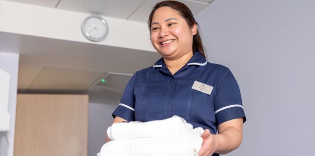 Nurse carrying laundry