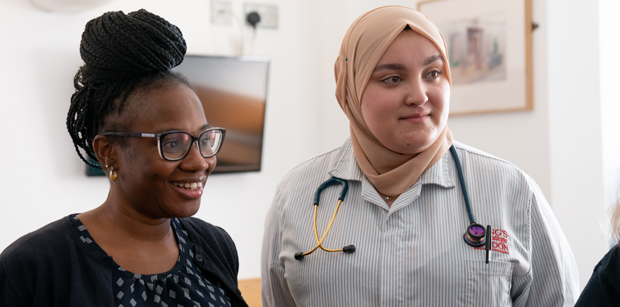 Members of staff talking to a patient