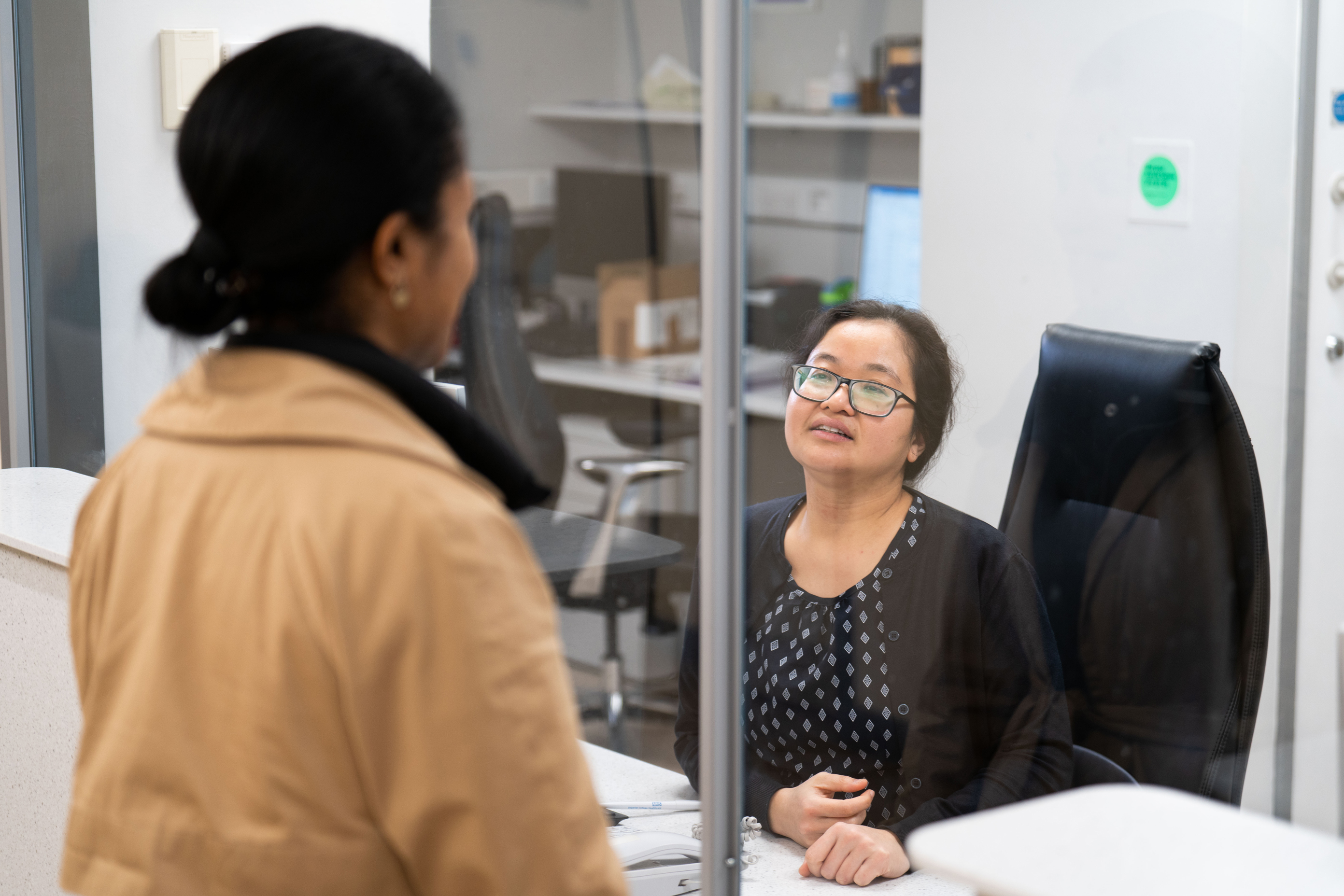 Patient talking to receptionist