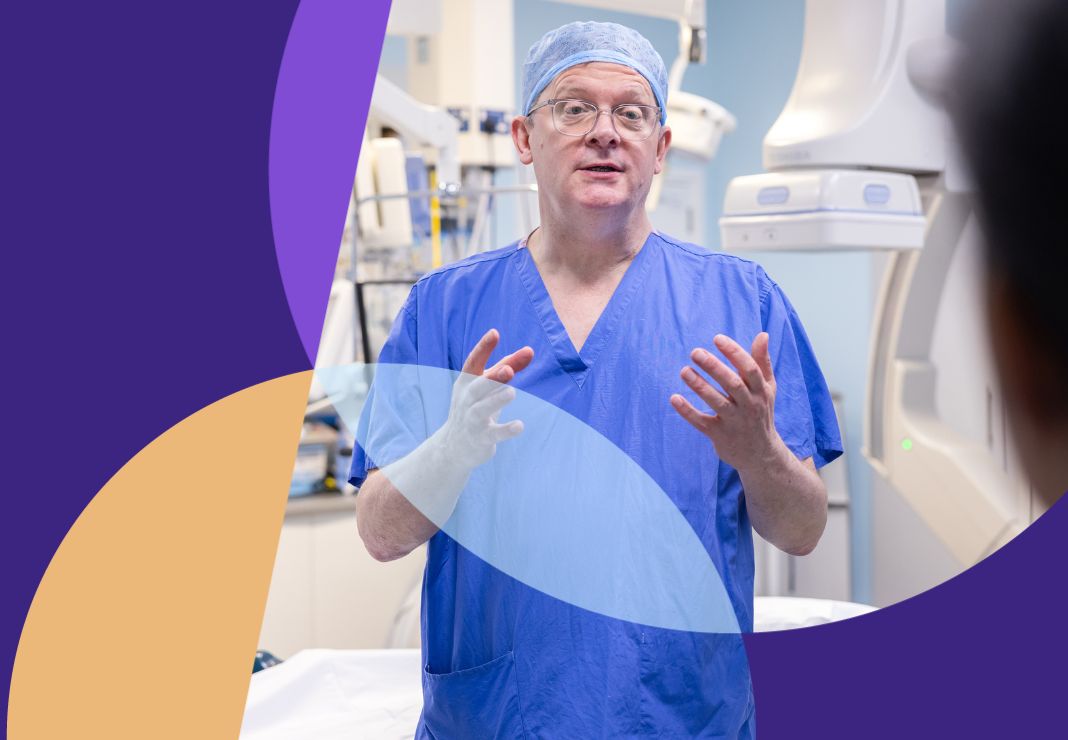 Cardiac surgeon Chris Baker talking to colleague in theatre