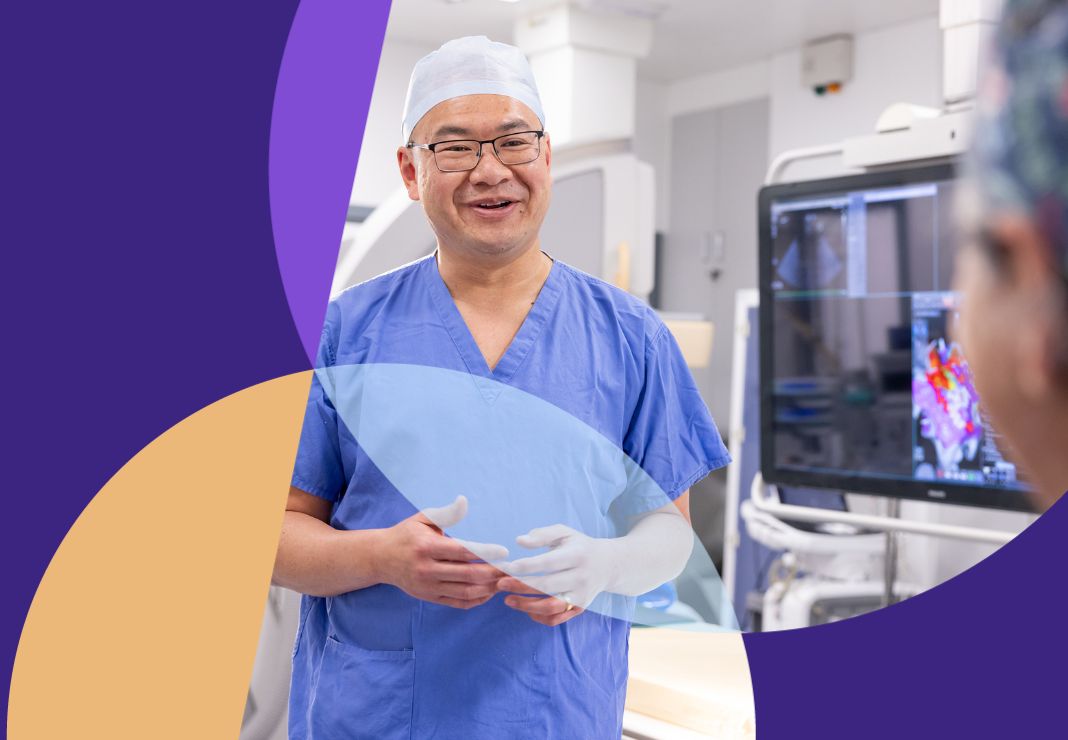 Cardiac surgeon talking to colleague in theatre