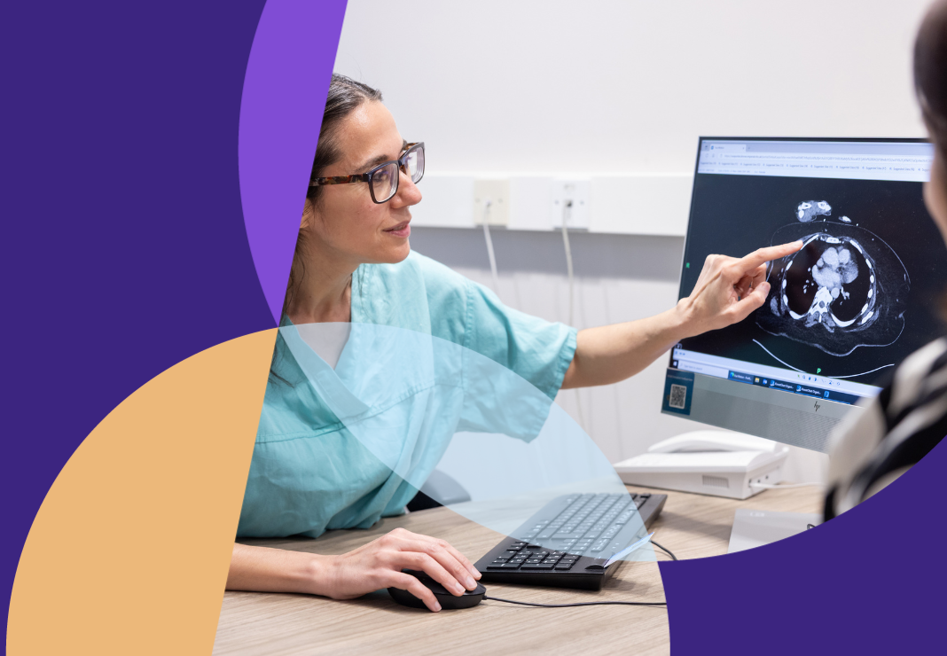 Gynaecology surgeon with patient talking through scan at a desk