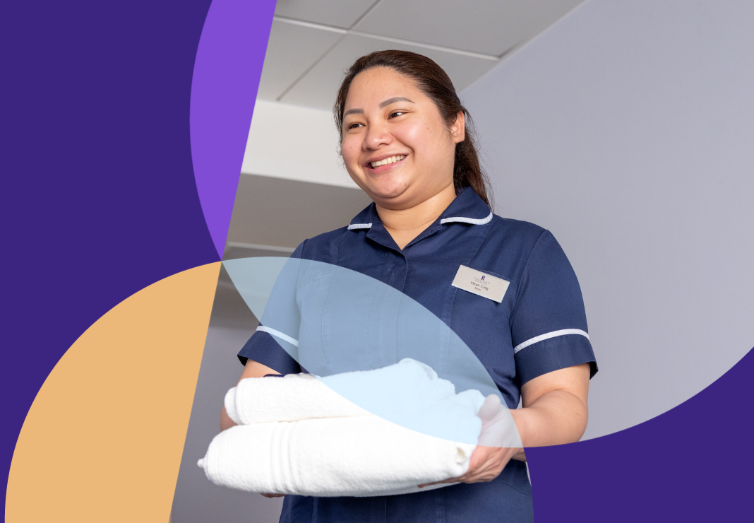Nurse carrying towels in private room
