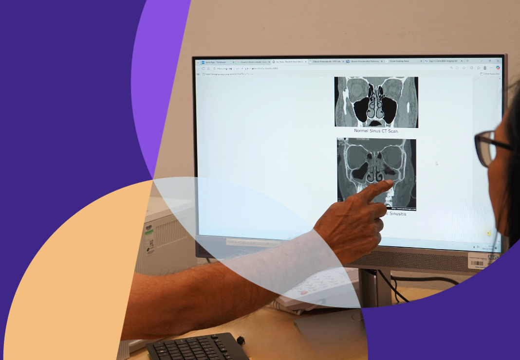 Consultant with patient looking at image of a nose