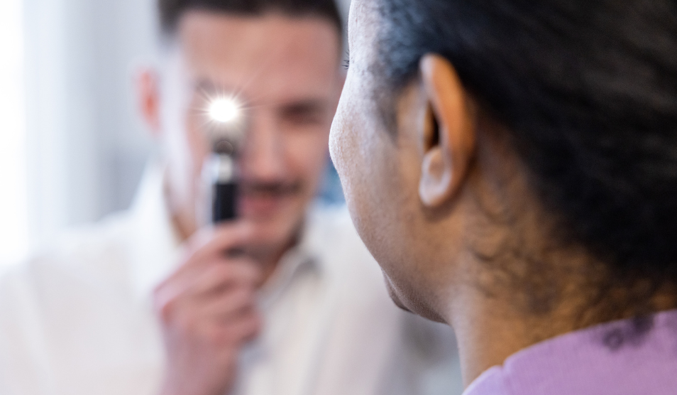 Ophthalmologist examining patient with eye torch