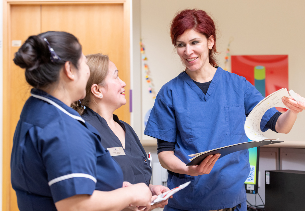 Consultant talking to two members of staff