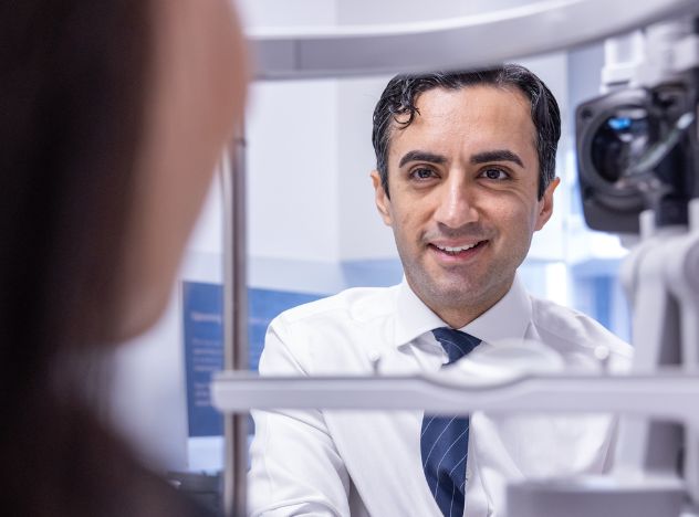 Nizar Din ophthalmologist with patient