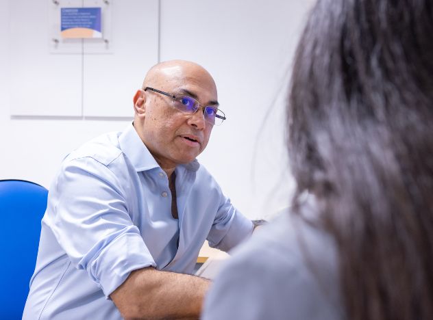 Krishna Moorthy, general surgeon, with patient