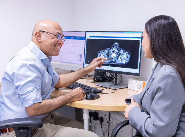 Krishna Moorthy, general surgeon with patient