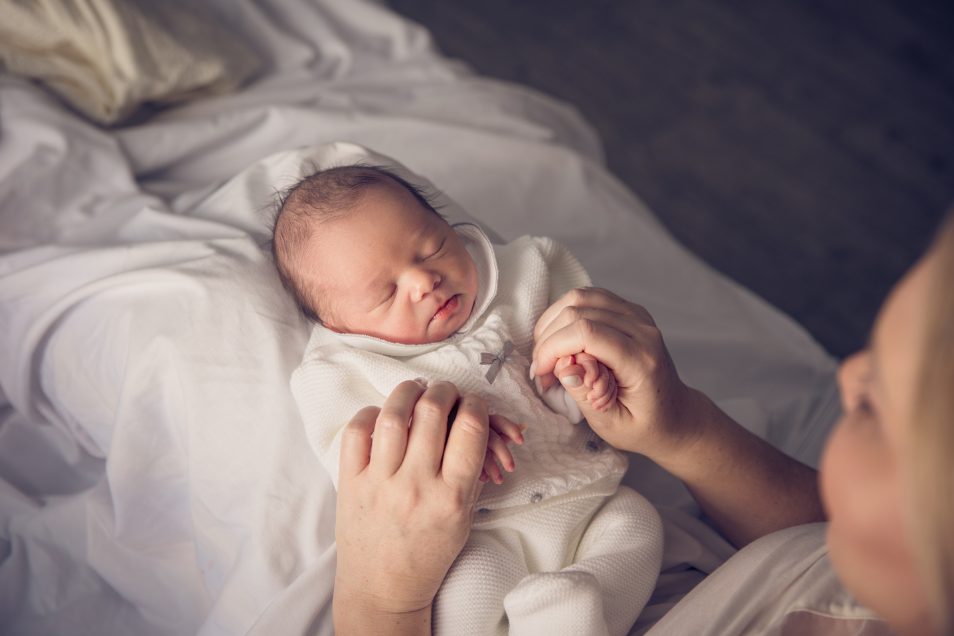 A mother holding her baby.
