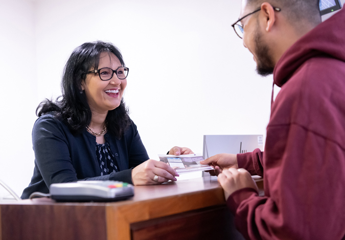 Receptionist talking to a patient